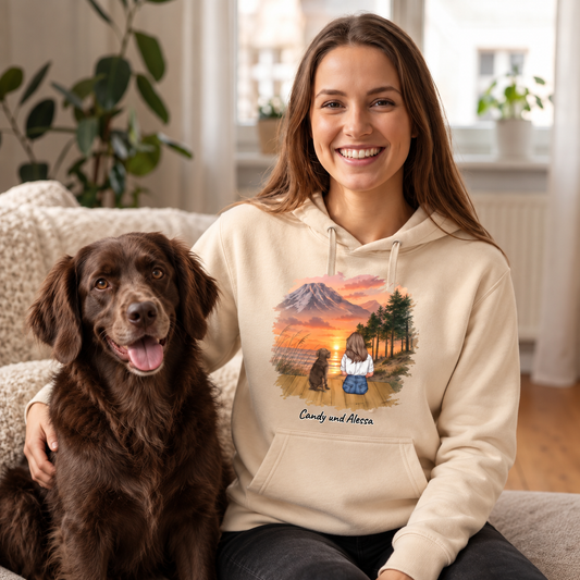 Beige hoodie met gepersonaliseerd motief van een vrouw en haar hond voor een berglandschap.
