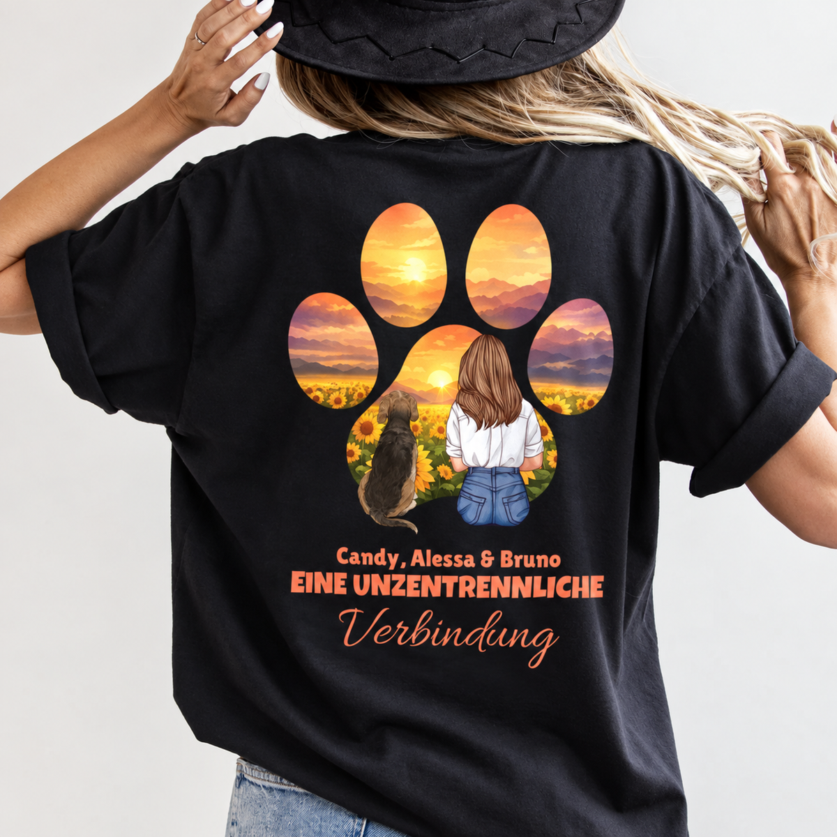 T-shirt noir avec dos imprimé, montrant une femme avec un chien devant un coucher de soleil et une inscription.