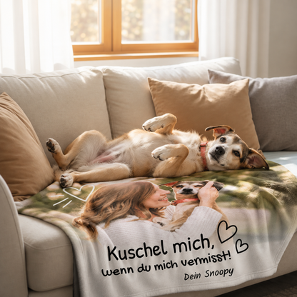 Gepersonaliseerde huisdierdeken met foto en tekst, licht materiaal, op een bank met een hond.