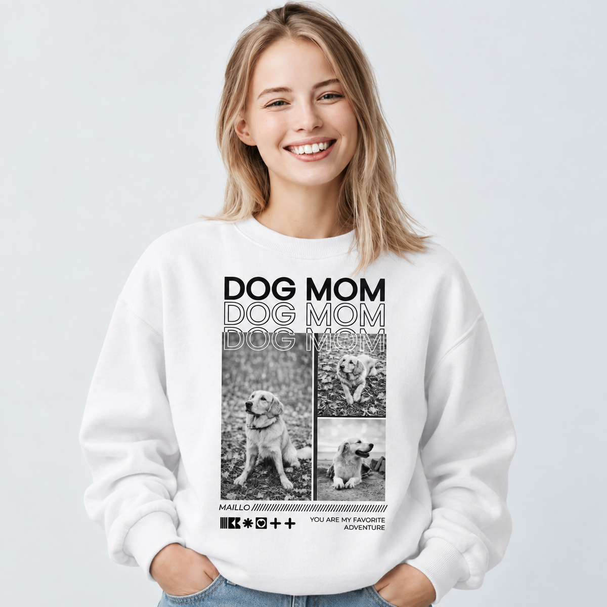 Witte sweater met "DOG MOM"-print en afbeeldingen van honden. De draagster lacht in de camera.