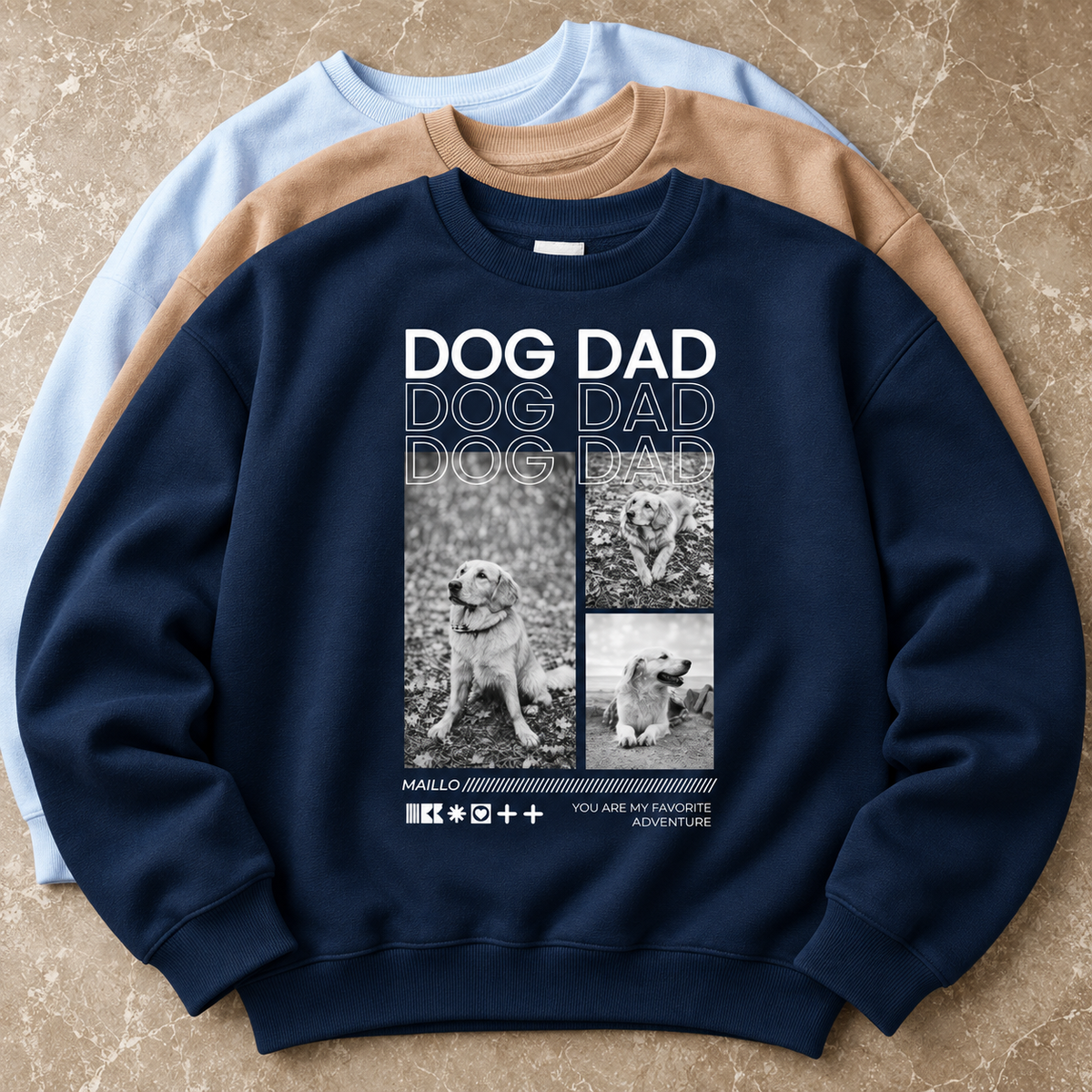 Drie sweaters in verschillende kleuren, één navy met Dog Dad-afbeelding en hondenfoto's.