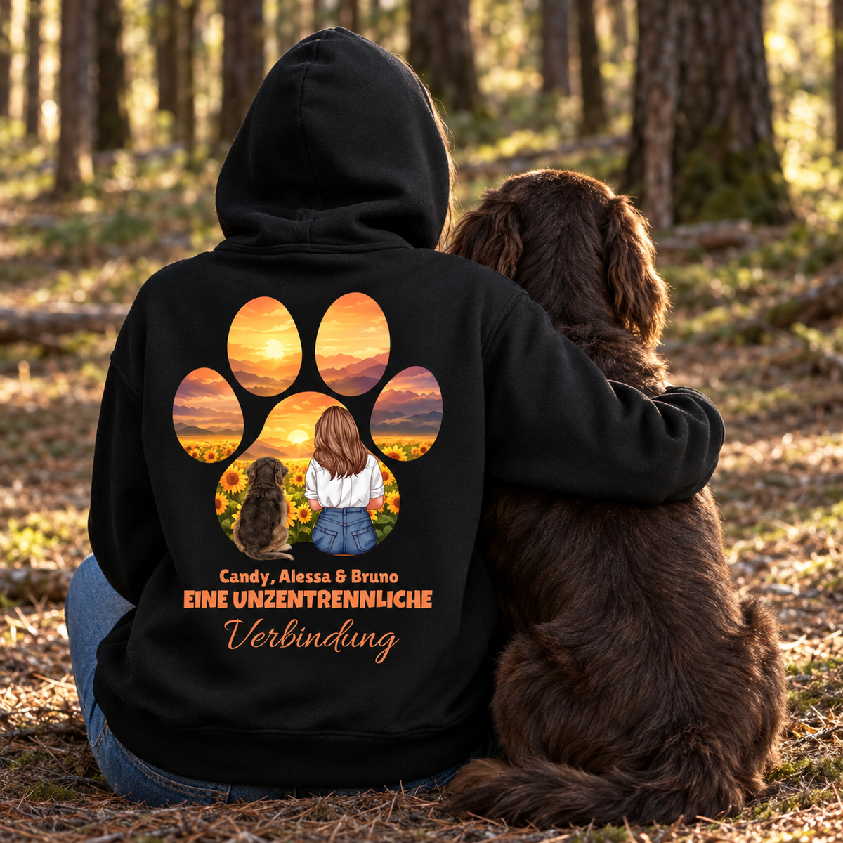 Zwarte hoodie met opdruk van een meisje en hond tussen zonnebloemen en de tekst "Eine unzertrennliche Verbindung".