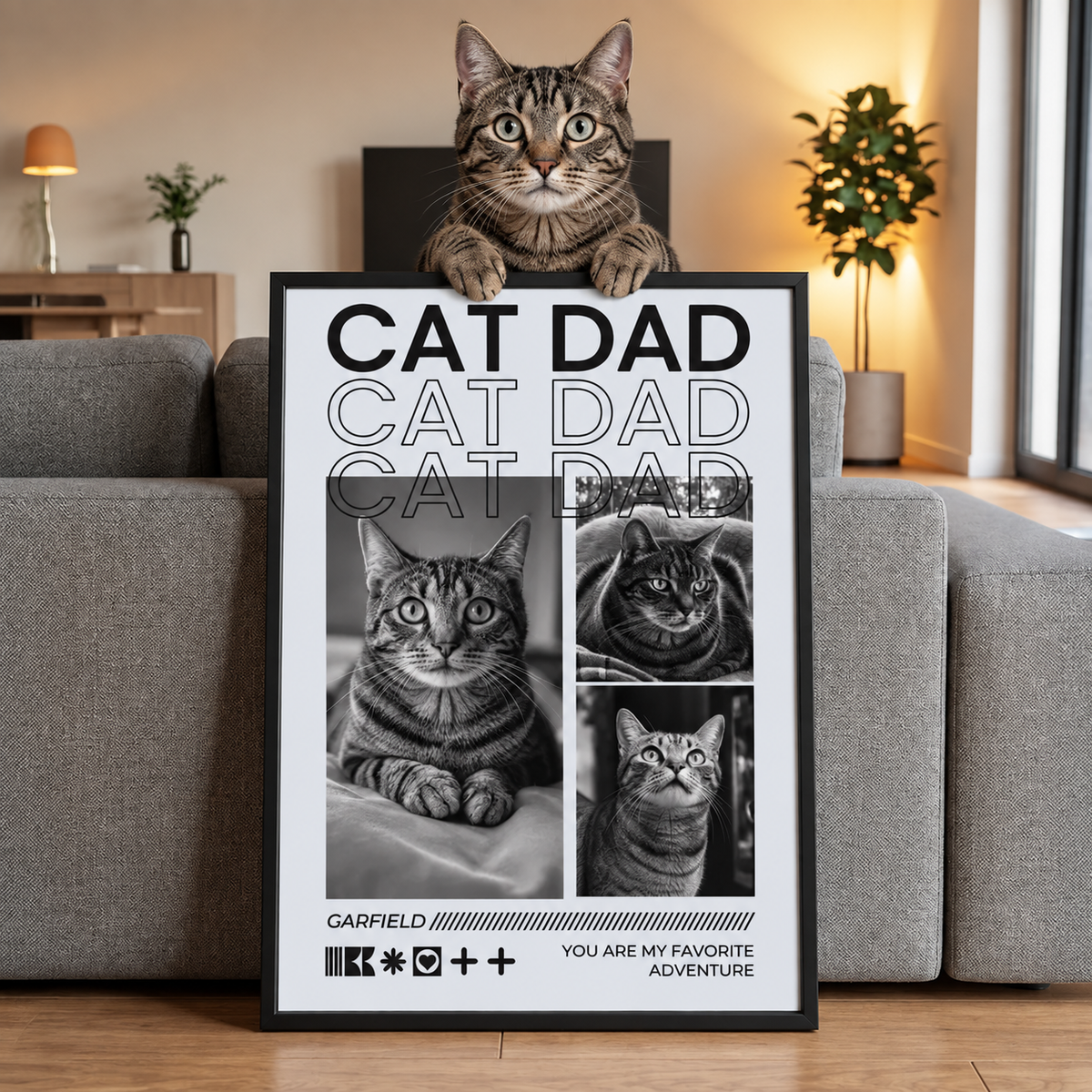 Chat assis sur un poster personnalisé avec l'inscription "CAT DAD" et des photos de différents chats.