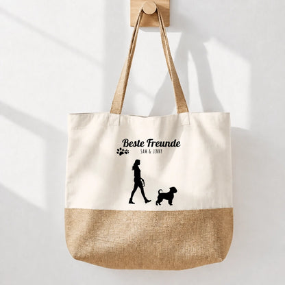 Beige stoffen boodschappentas met jute bodem en zwarte opdruk “Beste vrienden”. Silhouet van een persoon met hond.