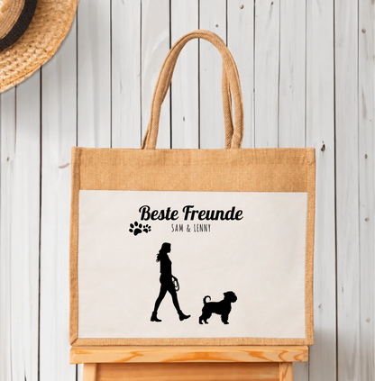 Gepersonaliseerde jute boodschappentas met zwarte silhouetten van persoon en hond. Opschrift “Beste vrienden”.