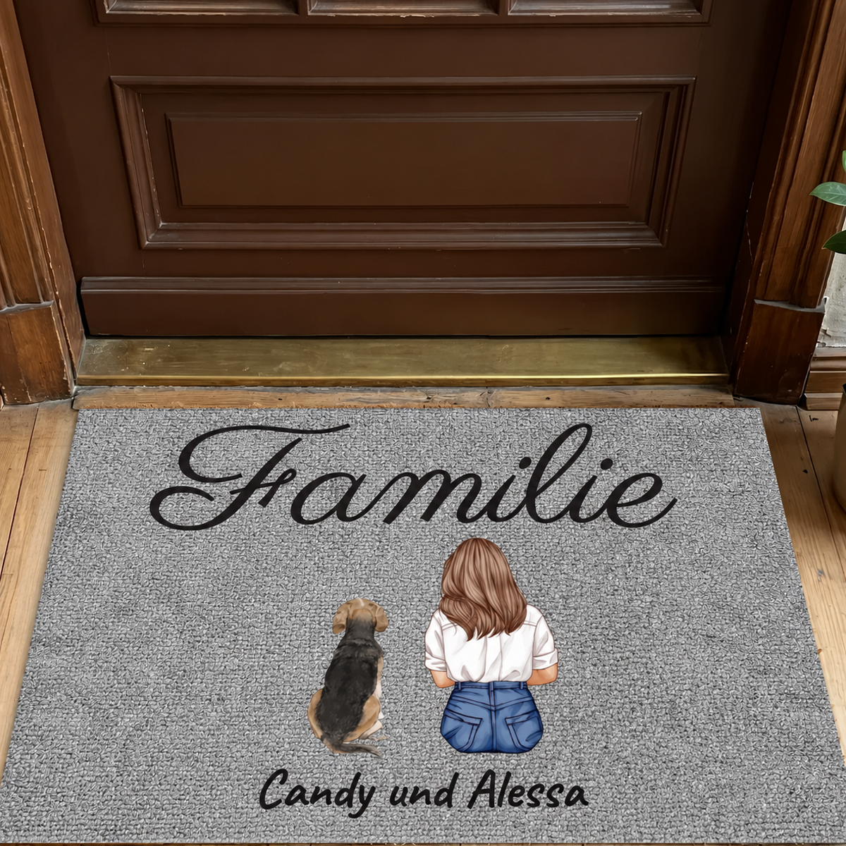Gepersonaliseerde grijze deurmat met opdruk "Familie" en illustraties van een meisje met een hond.